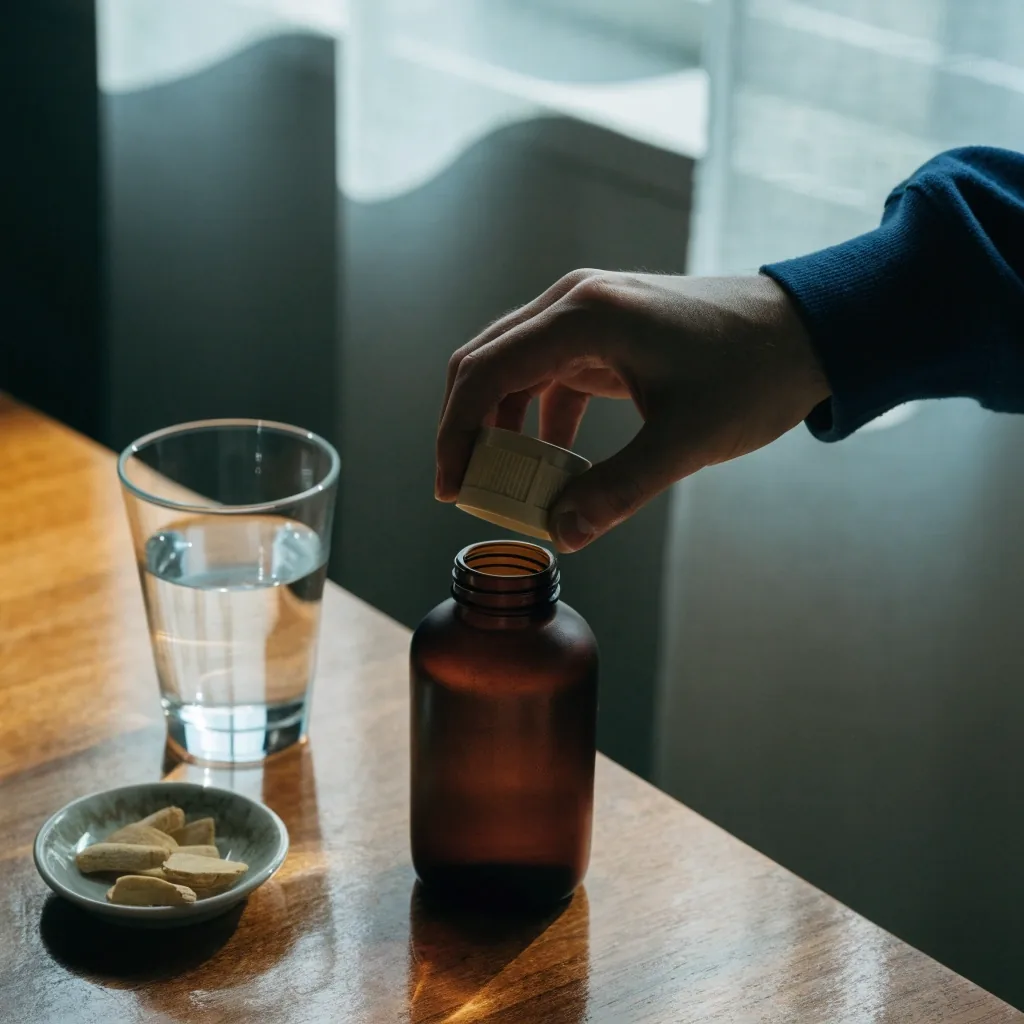 Glass of water on a timber ledge in overcast daylight